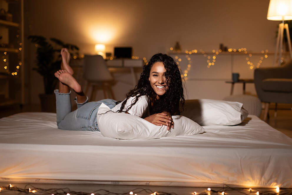happy-lady-lying-on-stomach-on-bed-relaxing-at-hom-2025-03-18-17-52-20-utc (1)